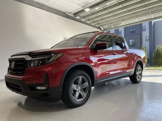 Red Honda Ridgeline at the open garage door